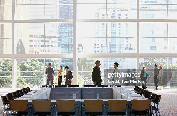 Group of people in meeting room with large window