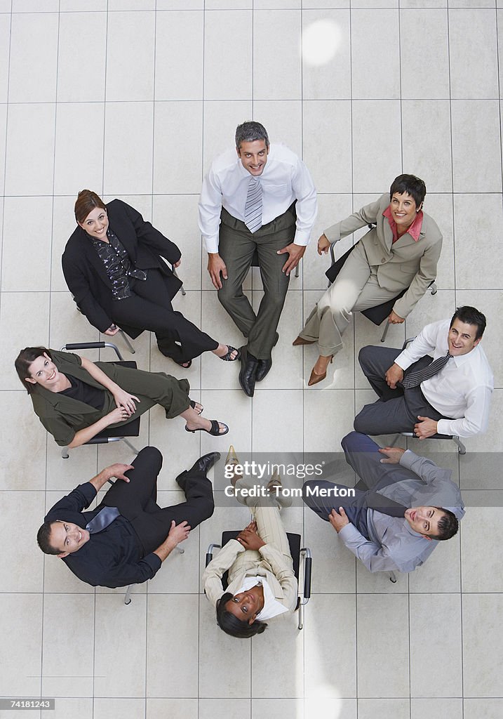 Aerial view of businesspeople in circle looking up