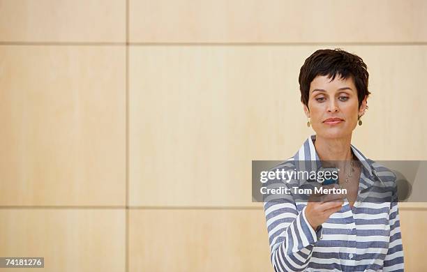 woman with cell phone - feature phone stockfoto's en -beelden