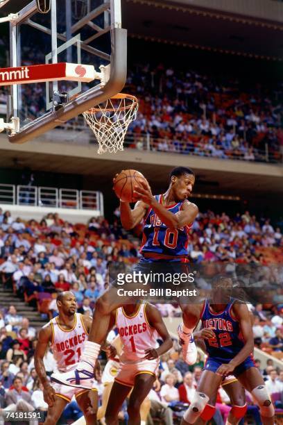 Dennis Rodman of the Detroit Pistons grabs a rebound against the Houston Rockets during a 1978 NBA game at the Summit in Houston, Texas. NOTE TO...