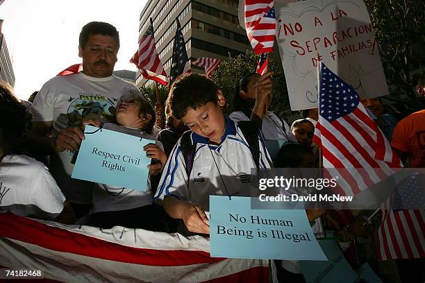 Protesters hold a march and rally denouncing the actions of Los Angeles riot police at a May Day immigrant rights rally at MacArthur Park on May 17,...