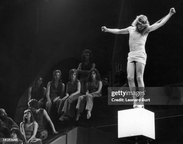 English actor and singer Paul Nicholas plays the crucified messiah in the musical 'Jesus Christ Superstar', on stage at the Palace Theatre, London,...