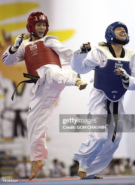 Thailand's Yaowapa Boorapolchai delivers a kick on to USA's Charlotte Craig in the women's 47kg quarterfinals of the World Taekwondo Championship in...