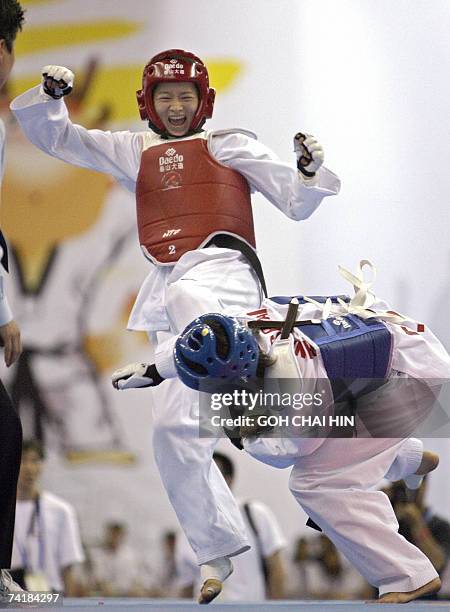 China's Wu Jingyu delivers a kick against Taiwan's Yang Shu Chun in the women's 47kg quarterfinals of the World Taekwondo Championship in Beijing 18...