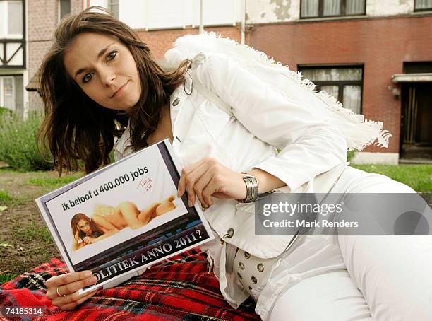 Tania Derveaux poses with her campaign poster on May 18, 2007 in Antwerp, Belgium. The Belgian politician of the Nee party has offered oral sex to...