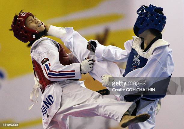 China's Wu Jingyu delivers a kick to the head of Thailand's Yaowapa Boorapolchai during the women's 47kg final in the World Taekwondo Championship in...