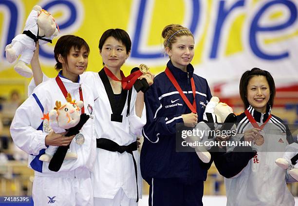 China's Wu Jingyu celebrates with Thailand's Yaowapa Boorapolchai , who won the silver medal, together with USA's Charlotte Craig and Taiwan's Yang...