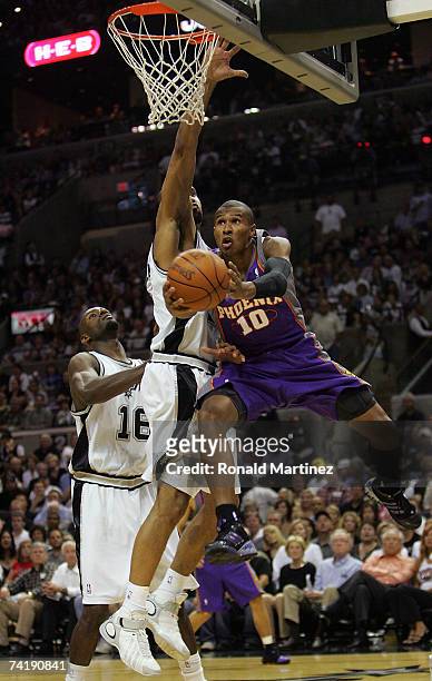 Guard Leandro Barbosa of the Phoenix Suns drives the hoop against Tim Duncan of the San Antonio Spurs in Game Six of the Western Conference...