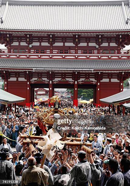 Participants carry a portable shrine during the Sanja Festival at Asakusa Shrine on May 19, 2007 in Tokyo, Japan. About one hundred portable shrines...