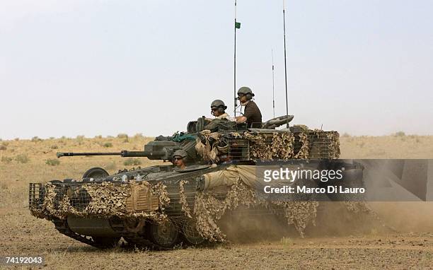 British Soldiers from the B Squadron of The Light Dragoons Regiment ride their Scimitar tank in a location in the desert to conduct counter Taliban...