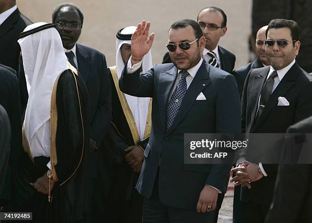 King Mohammed VI of Morrocco waves to wellwishers as he is flanked by Saudi King Abdullah as they arrive at the Royal Palace in Fes, 18 May 2007. The...