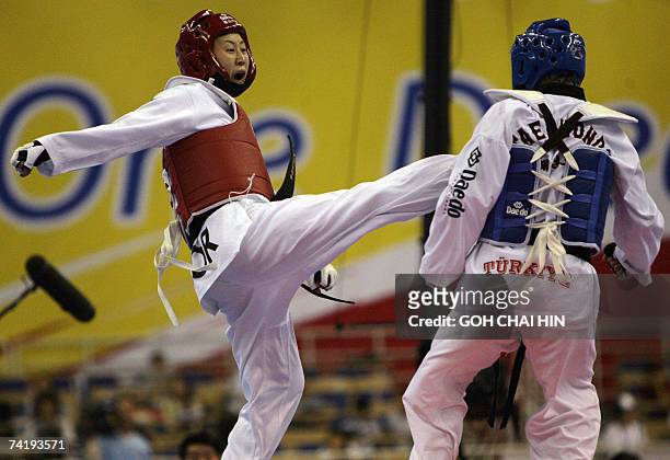 South Korea's Lee Sung-hye sends a kick towards Turkey's Hamide Bikcin in the women's under 59kg final of the World Taekwondo Championship in Beijing...