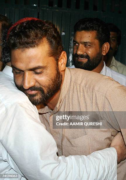Unseen deputy leader of Red Mosque Abdul Rashid Ghazi hugs the released Pakistani policemen in front of the mosque, in Islamabad, 19 May 2007. Dozens...
