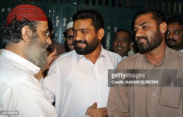 The deputy leader of Red Mosque Abdul Rashid Ghazi hugs the released Pakistani policemen in front of the mosque, in Islamabad, 19 May 2007. Dozens of...