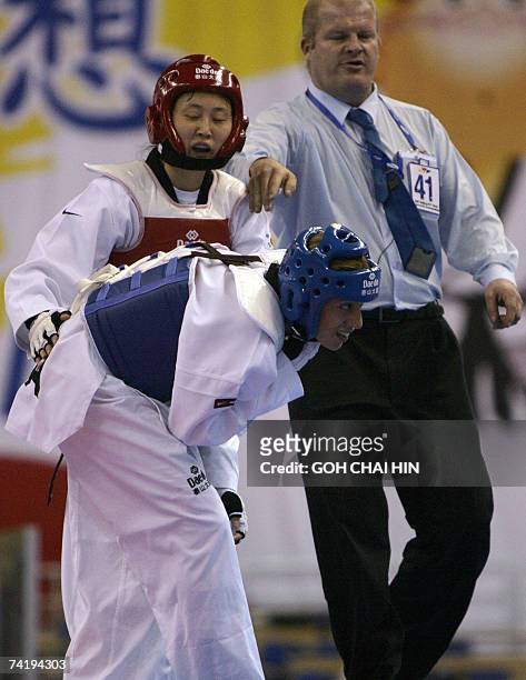 South Korea's Lee Sung Hye tries to consoles USA's Diana Lopez after she was injured, in the women's under 59kg semifinal bout of the World Taekwondo...