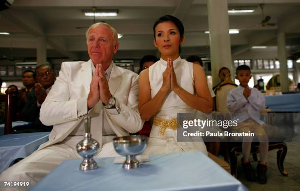 British groom Geoffrey Goodwin prays to the monks along side his Thai bride Ratanaporn during their traditional Thai wedding ceremony May 19, 2007 in...