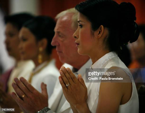 British groom Geoffrey Goodwin prays along side his Thai bride Ratanaporn at their traditional Thai wedding ceremony May 19, 2007 in Bangkok,...