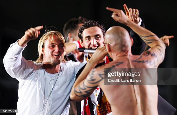 Timo Hildebrand and Roberto Hilbert celebrate with singer Thomas D of music band Fantastischen Vier during the VfB Stuttgart champion's party at...