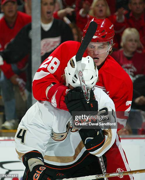 Brad May of the Anaheim Ducks is cluthed from behind by Tomas Kopecky of the Detroit Red Wings during the first period in game five of the 2007...