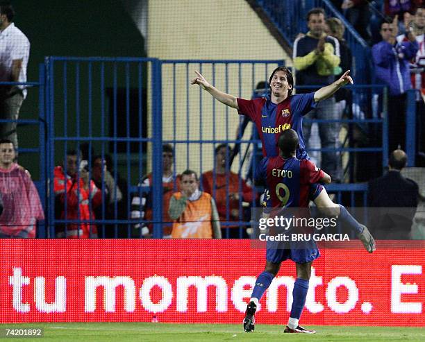 Barcelona?s Messi and Ronaldinho jubilate after a fifth goal during a Spanish league football match against Atletico de Madrid, 20 May 2007, at the...