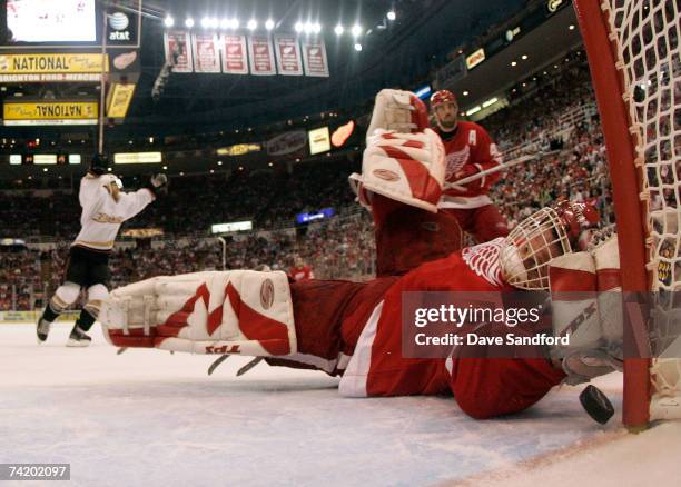 Goalie Dominik Hasek of the Detroit Red Wings lets in the game-winning goal in overtime against Teemu Selanne of the Anaheim Ducks in game five of...