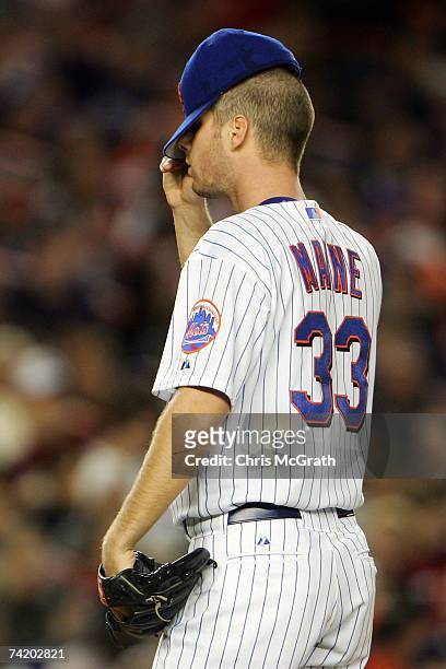 Starting pichter John Maine of the New York Mets adjusts his hat against the New York Yankees on May 20, 2007 at Shea Stadium in the Flushing...