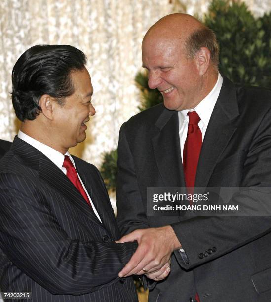 Microsoft CEO Steve Ballmer shakes hands with Vietnamese Prime Minister Nguyen Tan Dung as they attend a signing ceremony for a strategic partnership...