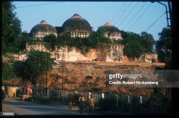 Members of a border security force guard a mosque from attack by militant Hindus October 29, 1990 in Ayodhya, India. While religious parallels and...
