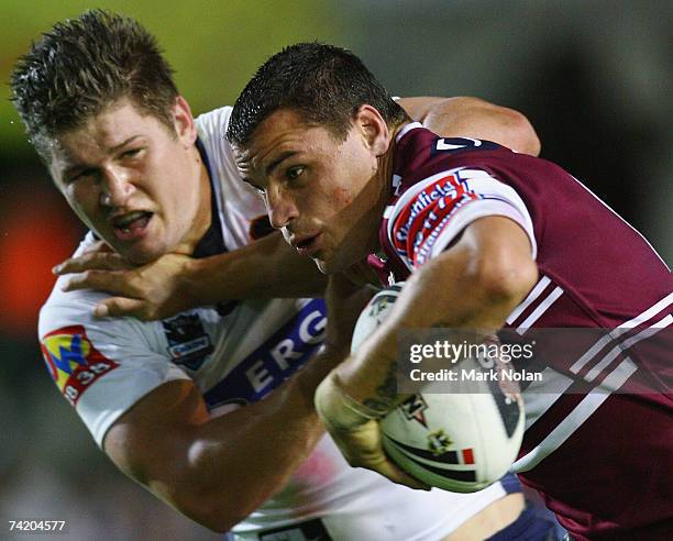 Anthony Watmough of the Eagles is tackled by Greg Eastwood of the Broncos during the round 10 NRL match between the Manly Warringah Sea Eagles and...