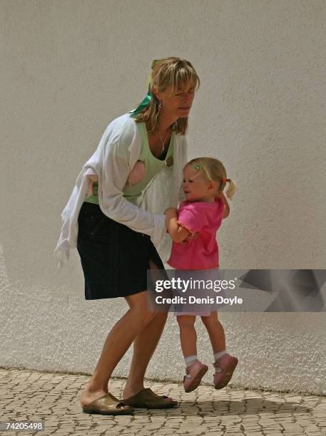 Kate McCann, the mother of missing girl Madeleine, carries her daughter Amelie back to their apartment on May 21, 2007 in Praia da Luz, Portugal....