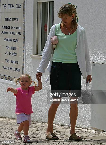Kate McCann, the mother of missing girl Madeleine, walks her daughter Amelie back to their apartment on May 21, 2007 in Praia da Luz, Portugal....