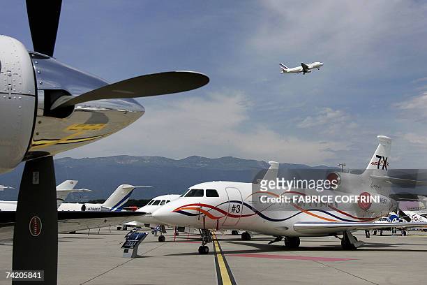 Commercial plane takes off behind business aircrafts with the newly certificated Dassault Falcon 7x during the press day of the 7th Annual European...