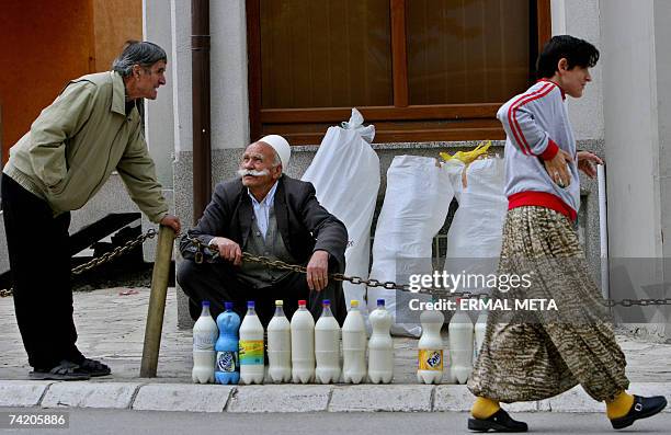 An ethnic Albanian street vendor sells bottles of milk on the pavement in Orahovac , 21 May 2007. Kosovo has been run by a United Nations mission...