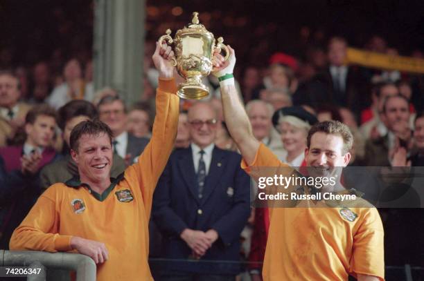 Australian scrum-half Nick Farr-Jones and winger David Campese lift the Webb Ellis Cup after Australia's 12-6 victory over England in the Rugby World...