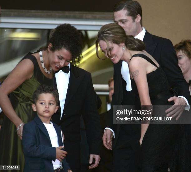 French journalist and writer Mariane Pearl smiles 21 May 2007 as she looks at her son Adam nyext to US actress Angelina Jolie and actor and producer...