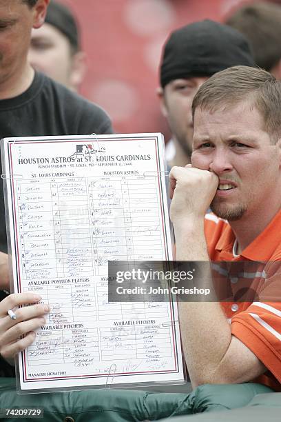 Fan holds up a souvenir lineup card prior to the game between the St. Louis Cardinals and the Houston Astros at Busch Stadium in St. Louis, Missouri...