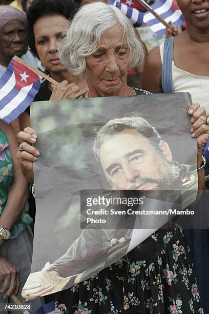 Women hold flags and posters of Fidel Castro Ruz during a "Federacion de Mujeres Cubanas" FMC rally supporting Castro and the Revolution on August...