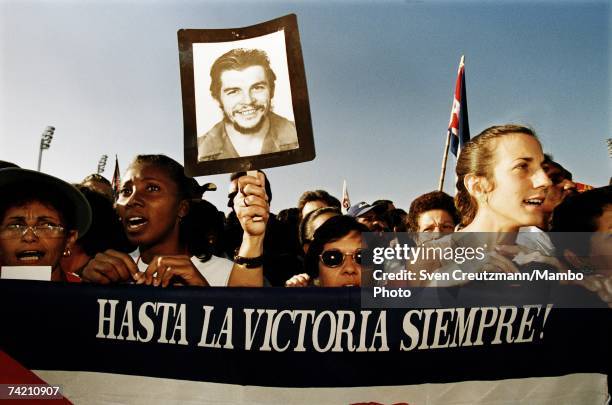 Participants march in a commemorative funeral procession on October 17, 1997 in Santa Clara, Cuba. The people are marking the funeral which Fidel...