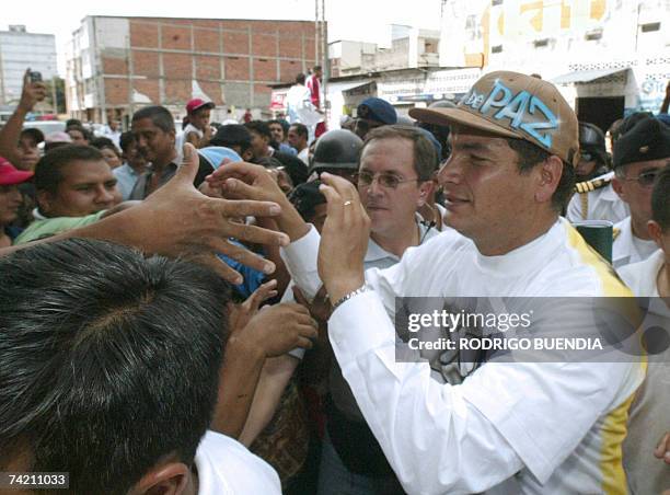 El presidente de Ecuador, Rafael Correa se saluda con vecinos del barrio de la Paz en Guayaquil el 21 de mayo de 2007. Correa visito microempresas de...