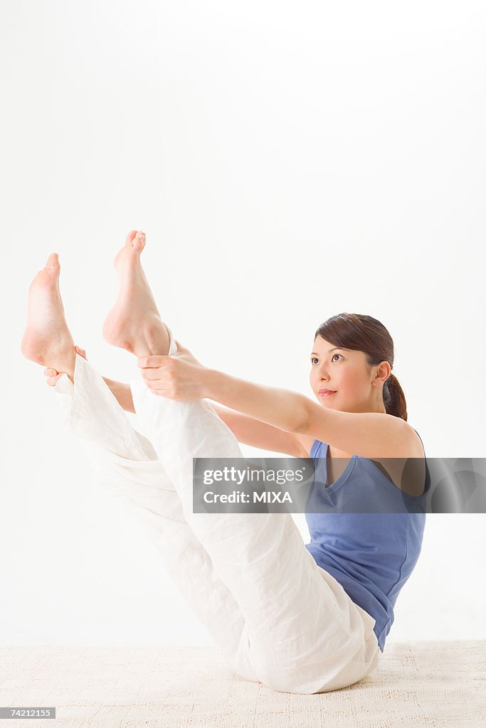 Young woman practicing Pilates