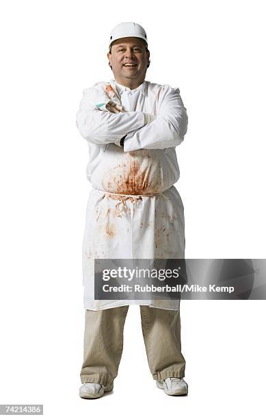 butcher standing with arms crossed smiling - butcher portrait stock pictures, royalty-free photos & images