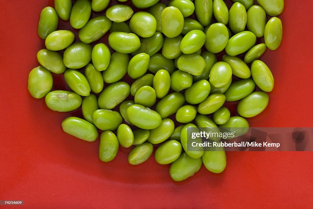 Closeup of lima beans with red background