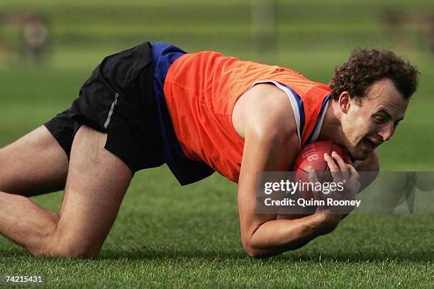 David Hale of the Kangaroos dives for a mark during a Kangaroos AFL training session at Arden Street May 22, 2007 in Melbourne, Australia.