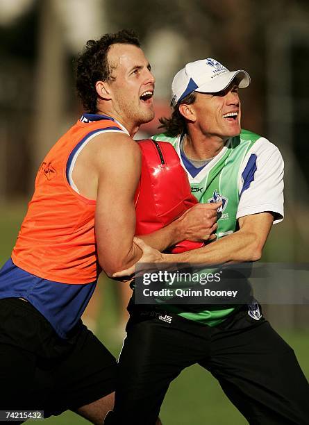 David Hale and Dean Laidley the coach of the Kangaroos compete in ruck drills during a Kangaroos AFL training session at Arden Street May 22, 2007 in...