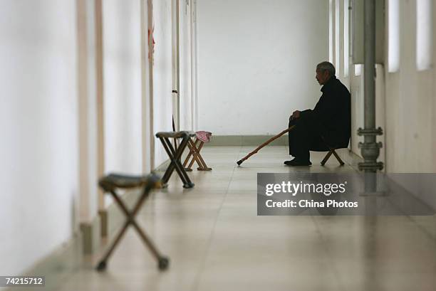 Senior citizen sits at the corridor of a care center on May 22, 2007 in Zibo of Shandong Province, China. According to state media, China is moving...