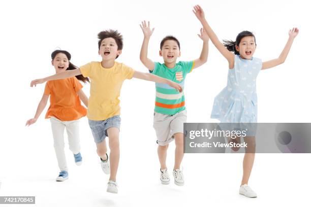 cheerful school students hand in hand running - girls with short skirts photos et images de collection