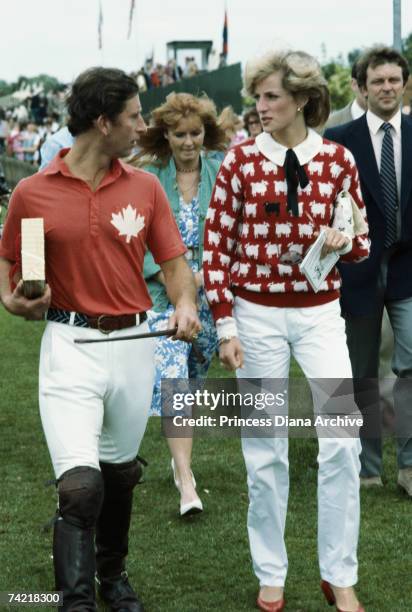 Princess Diana in a Smith's Lawn sweater, with Prince Charles at a polo meeting at Windsor, June 1983. With them is Sarah Ferguson .