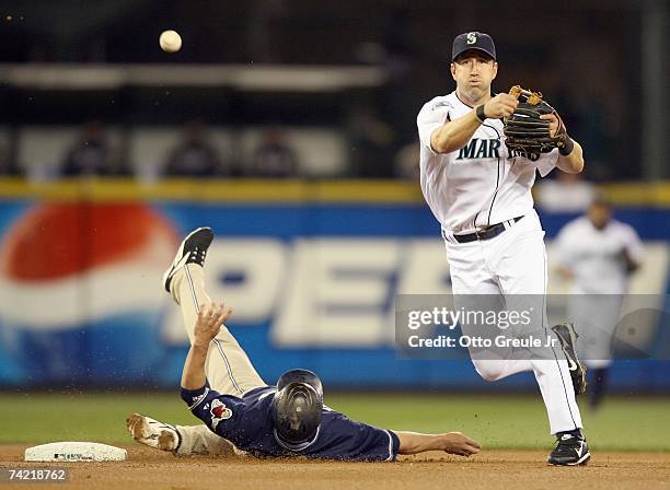 Willie Bloomquist of the Seattle Mariners tags out Marcus Giles of the San Diego Padres as he throws to firstbase at Safeco Field on May 19, 2007 in...