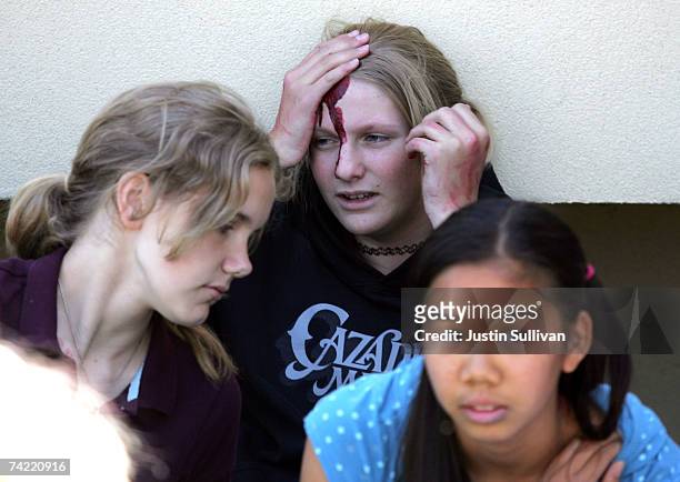 Volunteer students wearing makeup to simulate injuries participate in a school shooting and mass evacuation drill at Lincoln Middle School May 22,...