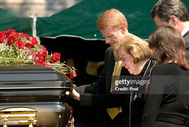 Macel Falwell touches the casket of her late husband, Rev. Jerry Falwell, as her children, Jonathan , Jerry Jr. And Jeannie Savas join her during...